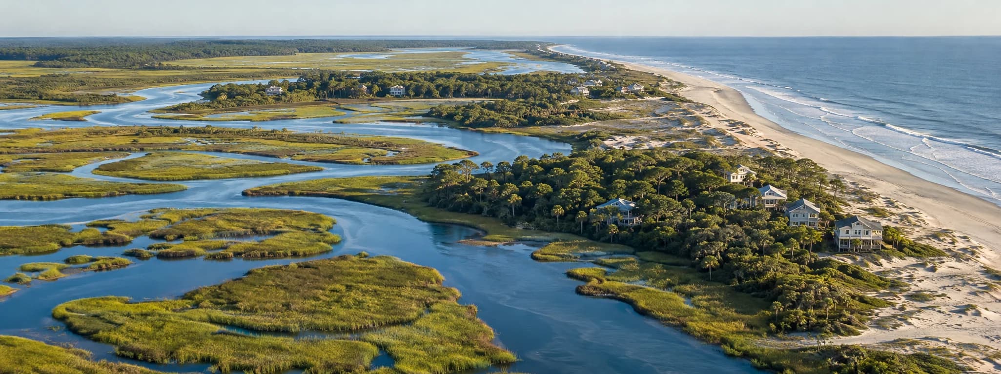 Aerial view of a Georgia barrier island, tidal creeks, marsh, and coastal homes